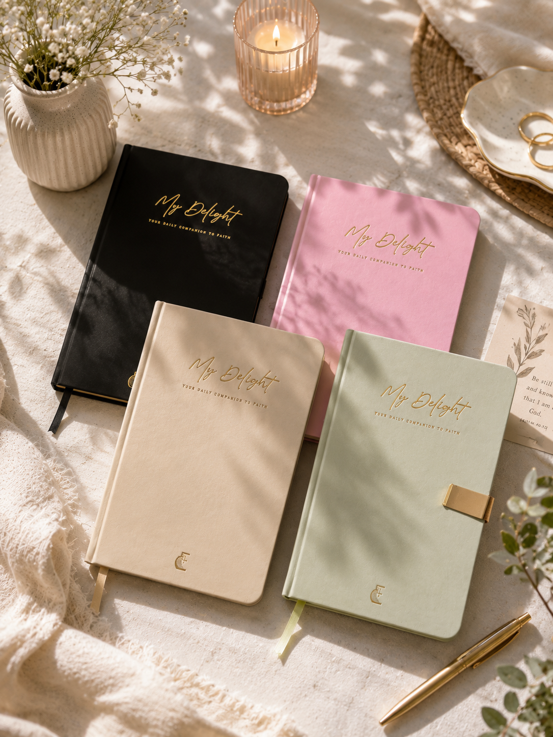 Four My Delight devotional journals in a sunlit flat lay